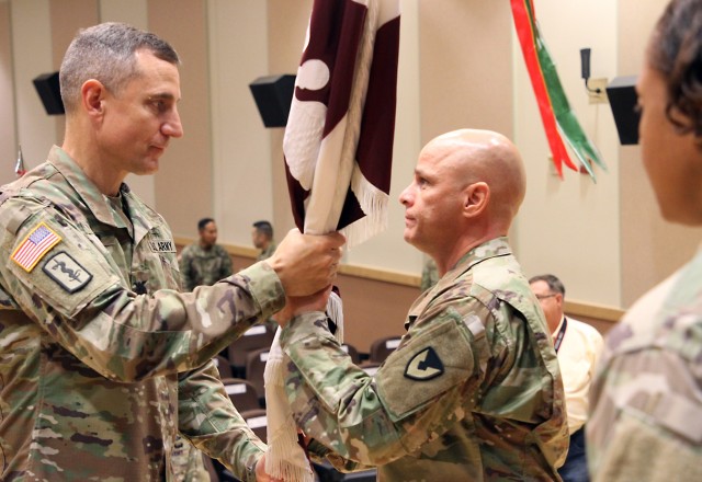 Col. Derek C. Cooper, left, passes the colors to Lt. Col. Marcus D. Perkins, signifying his assumption of command of the U.S. Army Medical Materiel Center-Korea, a direct reporting unit of Army Medical Logistics Command. Cooper, commander of the...