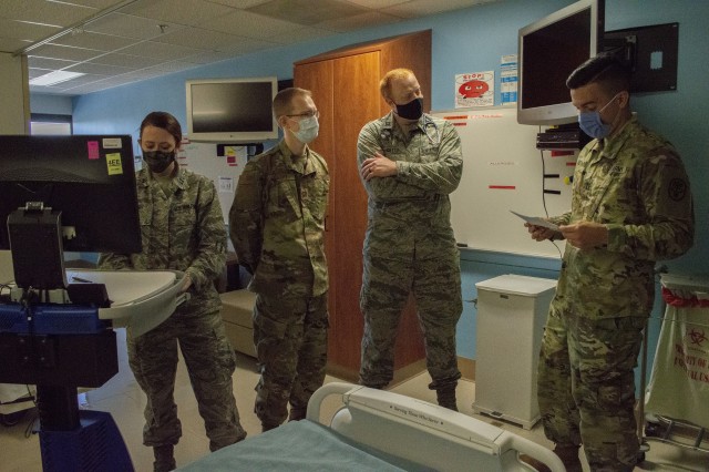 Army Capt. Mateo Betancourt goes over a patient’s chart with Air Force Capt. Danny Catts and Air Force Capt. James Barry while Air Force Capt. Jessika Weber focuses on the monitor in the Pediatrics ward at Brooke Army medical Center. Each of the doctors completed their residency and graduated from the San Antonio Uniformed Services Health Education Consortium in June. (U.S. Army Photo by Daniel J. Calderón)