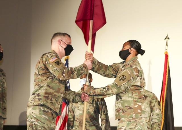 Col. Michael Weber, commander, Landstuhl Regional Medical Center, receives the unit guidon from Col. Stacy Freeman, outgoing commander, Wiesbaden Army Health Clinic, during a change of command and responsibility ceremony, June 12.