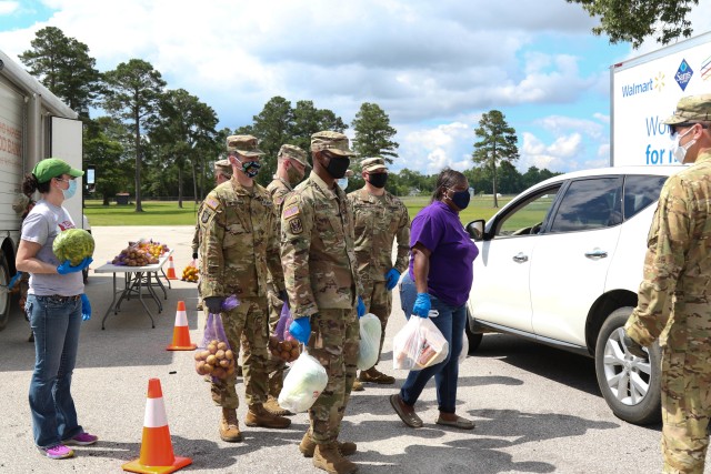 North Carolina Army National Guard Soldiers of the 449th Theater Aviation Brigade work alongside volunteers from Team Rubicon, a veteran disaster relief service organization, Action Pathways, a non-profit organization, and the Second Harvest Food...