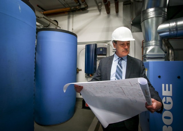 William McCarthy, facility director for Landstuhl Regional Medical Center and Regional Health Command Europe, checks blueprints for recently-installed water treatment equipment at LRMC. McCarthy, was recently recognized as the civilian of the year for 2019.