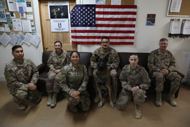 U.S. Army Soldiers from the 994th Medical Detachment (Veterinarian Services) stand with U.S. Air Force Staff Sgt. Juan Reyes and his Military Working Dog Cvoky in Kuwait on June 15, 2020. The Soldiers of the 994th provided medical assistance to...