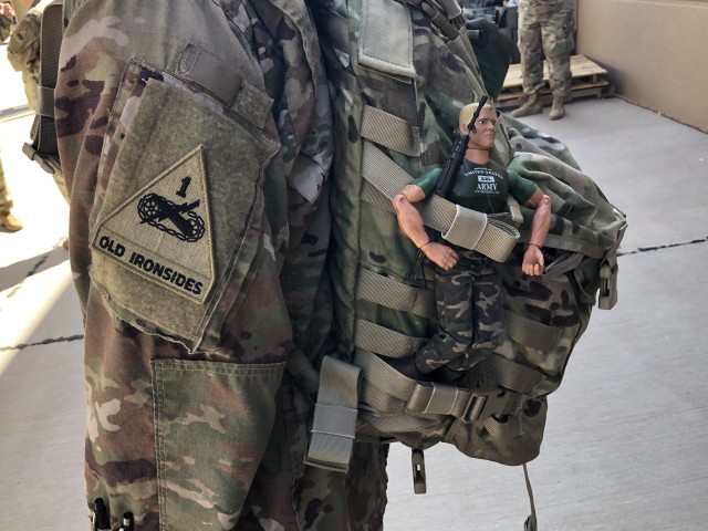 Bosnia Bob hangs on awaiting the bus to the Fort Bliss airfield on Aug. 1 2019 beginning his sixth deployment with Chaplain Lt. Col. Douglas Ball II. Bob is the traveling companion of 1st Armored Division Chaplain Lt. Col. Douglas Ball II. Photos...