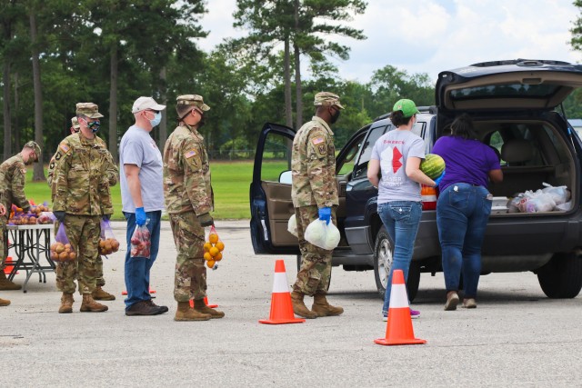 North Carolina Army National Guard Soldiers of the 449th Theater Aviation Brigade work alongside volunteers from Team Rubicon, a veteran disaster relief service organization, Action Pathways, a non-profit organization, and the Second Harvest Food...