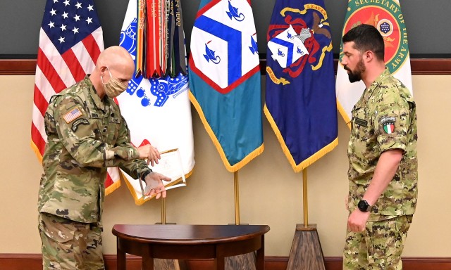 Col. Scott Green, Command and General Staff School director, presents the General Dwight D. Eisenhower Award, which recognizes the most distinguished international graduate of each Command and General Staff Officer Course class, to Italian Maj. Alessio Battisti during a small, socially-distanced awards ceremony for 2020 CGSOC award recipients June 11 in Marshall Lecture Hall at the Lewis and Clark Center. Photo by Mark Wiggins/Command and General Staff College Foundation