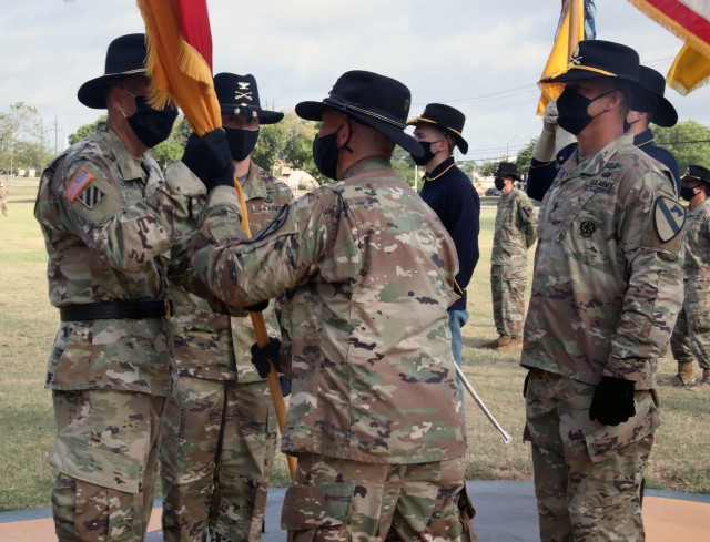 FORT HOOD, TX -- Col. Kevin Capra, outgoing commander of the 3rd Armored Brigade Combat Team “Greywolf,” 1st Cavalry Division passes the Brigade's colors to Maj. Gen. Jeff Broadwater, 1st Cavalry Division commander as incoming Greywolf...