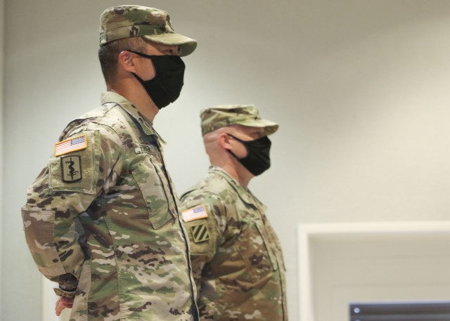 Command Sgt. Maj. Anthony Forker (left) , and Master Sgt. Richard Chandler, stand at parade rest during a change of responsibility ceremony, where Forker relinquished responsibility as LRMC’s Troop Command command sergeant major to Chandler, as interim command sergeant major, June 5.