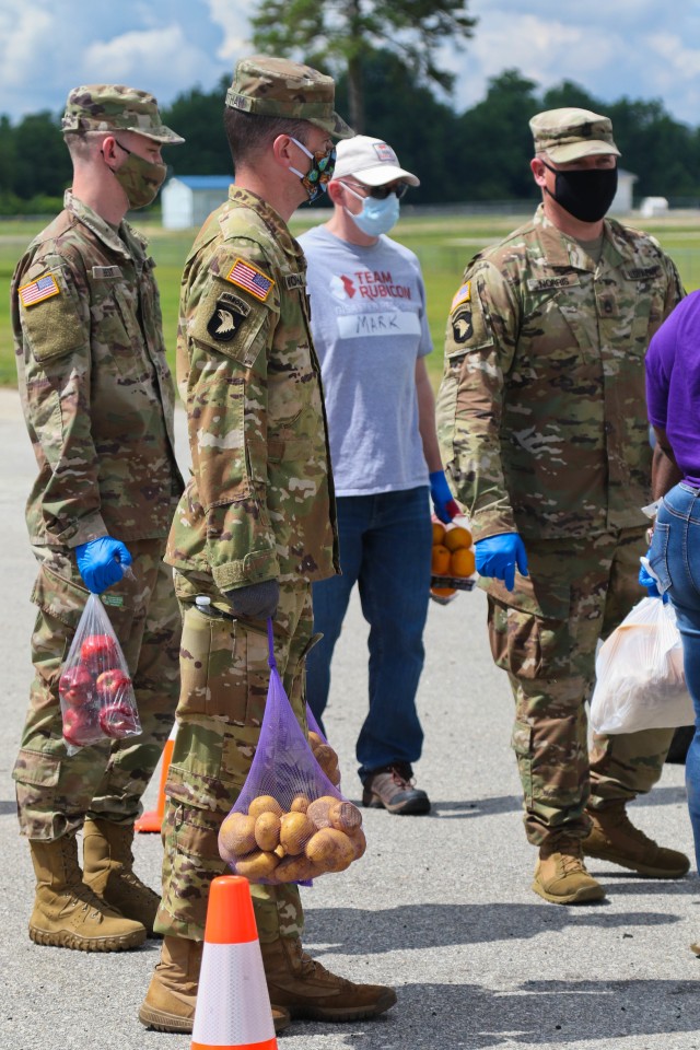 North Carolina Army National Guard Soldiers of the 449th Theater Aviation Brigade work alongside volunteers from Team Rubicon, a veteran disaster relief service organization, Action Pathways, a non-profit organization, and the Second Harvest Food Bank Southeast to distribute food to approximately 250 families at the Midway Elementary School in Dunn, N.C., June 18, 2020. The NCNG is working with North Carolina Emergency Management, N.C. Department of Health and Human Services and local food banks to help support COVID-19 relief efforts. (North Carolina Army National Guard photo by Spc. Hannah Tarkelly, 382nd Public Affairs Detachment/Released).