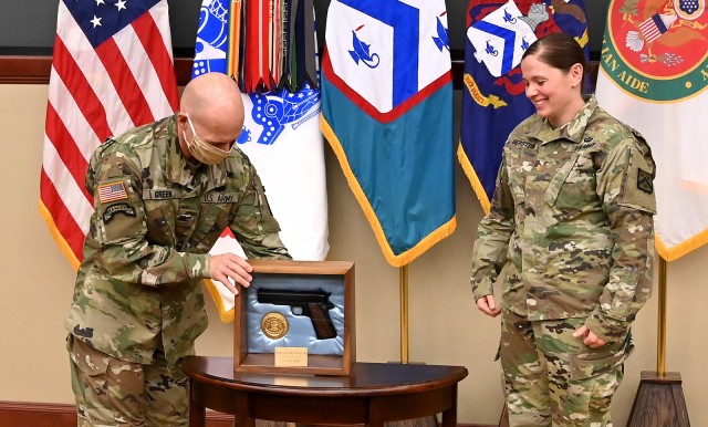 Col. Scott Green, Command and General Staff School director, presents the General George C. Marshall Award, recognizing the most distinguished U.S. graduate in each Command and General Staff Officer Course class, to Maj. Sarah Gerstein during a small, socially-distanced awards ceremony for 2020 CGSOC award recipients June 11 in Marshall Lecture Hall at the Lewis and Clark Center. Photo by Mark Wiggins/Command and General Staff College Foundation