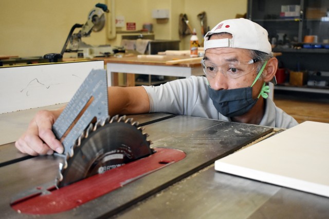 Yoshinori Kuriki, a hobby craft instructor at the Camp Zama Arts and Crafts Center, adjusts a saw blade at the center’s woodshop at Camp Zama, Japan, June 23.