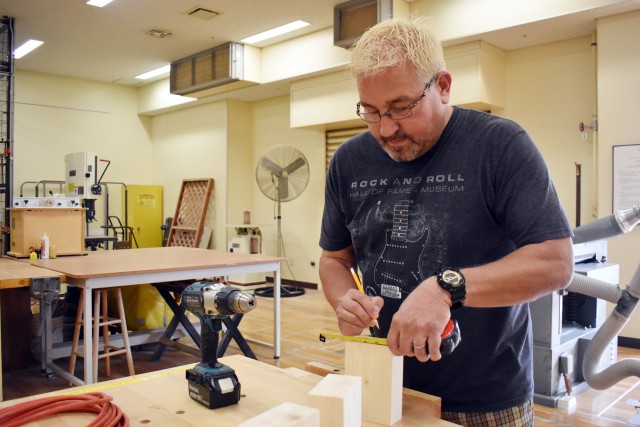 Wayne Hatfield prepares to drill a hole in a candleholder at the Camp Zama Arts and Crafts Center’s woodshop at Camp Zama, Japan, June 24.