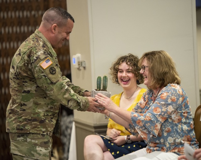 Maj. Gen. Steven A. Shapiro, outgoing commanding general of ASC, presents his wife, Mary, with a cactus during a change of command ceremony held at Rock Island Arsenal, Illinois, on June 24.