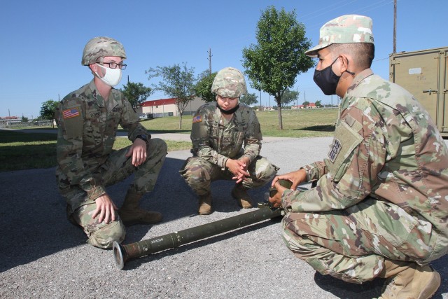 Staff Sgt. Ivan Peralta, 14P Air and Missile Defense instructor, right, responds to a question asked by Pvt. Joerico Sovine, left, an Advanced Individual Training Soldier. Peralta was quizzing Sovine and Pfc. Octavia Martin on the Stinger Man-Portable Air Defense System June 6, 2020, at Fort Sill, Okla.