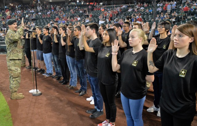 Lt. Col. Scott Morley, commander of the Phoenix Recruiting Battalion, administers the oath of enlistment to 40 future Soldiers, Aug. 26, 2018, at Chase Field before an Arizona Diamondbacks game. U.S. Army Recruiting Command plans to soon launch Army National Hiring Days, a major hiring event from June 30 to July 2, 2020, that aims to place 10,000 more recruits in boots. 