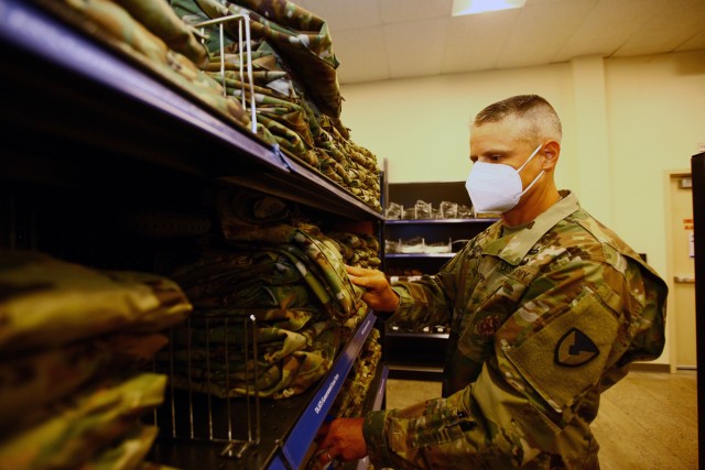 Fort Sill Garrison Command Sgt. Maj. Russell Blackwell looks over uniform items at the new Military Clothing and Sales Store June 23, 2020. The MC&SS offers an expanded selection of combat boots, sportswear, and post souvenirs.