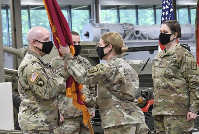 Brig. Gen. Heidi J. Hoyle, outgoing Chief of Ordnance, passes the corps’ colors to Maj. Gen. Rodney D. Fogg, CASCOM and Fort Lee commanding general, during the Ordnance Corps Relinquishment of Command Ceremony this morning at the Ord. Training...