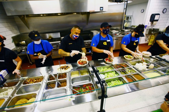 Qdoba Mexican Eats employees serve customers June 23, 2020, during the grand reopening at the Fort Sill PXtra.