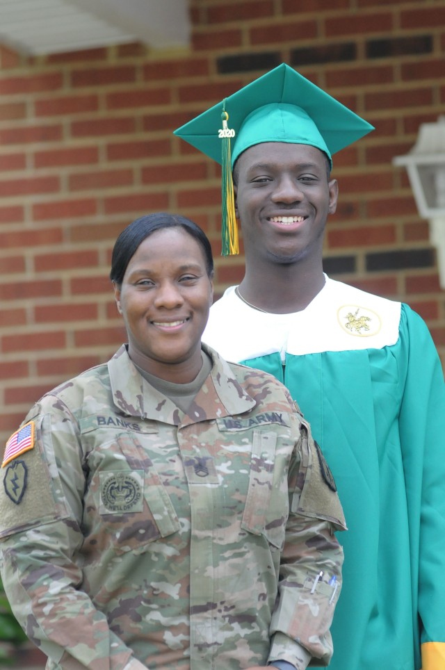 Staff Sgt. Shalanda Banks, Victor Company, 262nd Quartermaster Battalion, and her son, Jihad Banks, pose in front of their residence recently. Jihad is a Prince George High School (Va.) graduate whose desire for a traditional graduation ceremony was wiped out by COVID-19 restrictions.