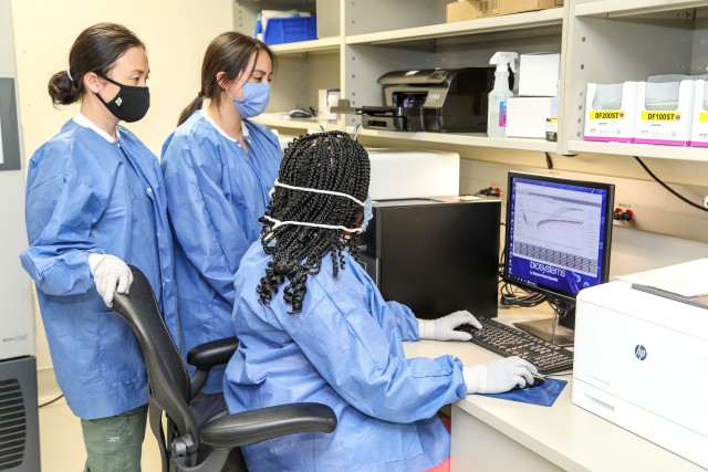 Eunjoo Kim, Leia Watson and Leslie Contreras, members of the molecular team, load COVID-19 patient samples into an analyzer at Brooke Army Medical Center, Fort Sam Houston, Texas, June 1, 2020. BAMC’s laboratory technicians are supporting the global effort in the fight against COVID-19. (U.S. Army photo by Senior Master Sgt. Sarah Hanaway)