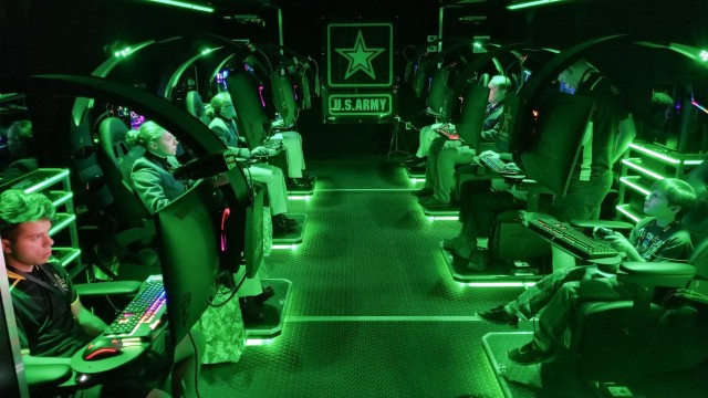 Visitors play video games inside a semitrailer belonging to the U.S. Army Recruiting Command&#39;s esports team during the Association of the U.S. Army&#39;s Annual Meeting and Exposition in Washington, D.C, Oct. 14, 2019. The command plans to create a cyber esports team and roll out autonomous recruiting operations, which will increase the mobility of recruiters with a larger social media presence.  