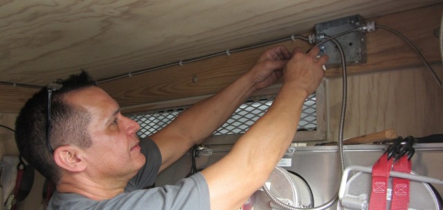 Jose Marrero, project/task supervisor for the European Theater, installs an Integrated Commercial Intrusion Detection System (ICIDS) sensor in a portable armory while working for Tobyhanna Army Depot’s Regional Support Center detachment in...