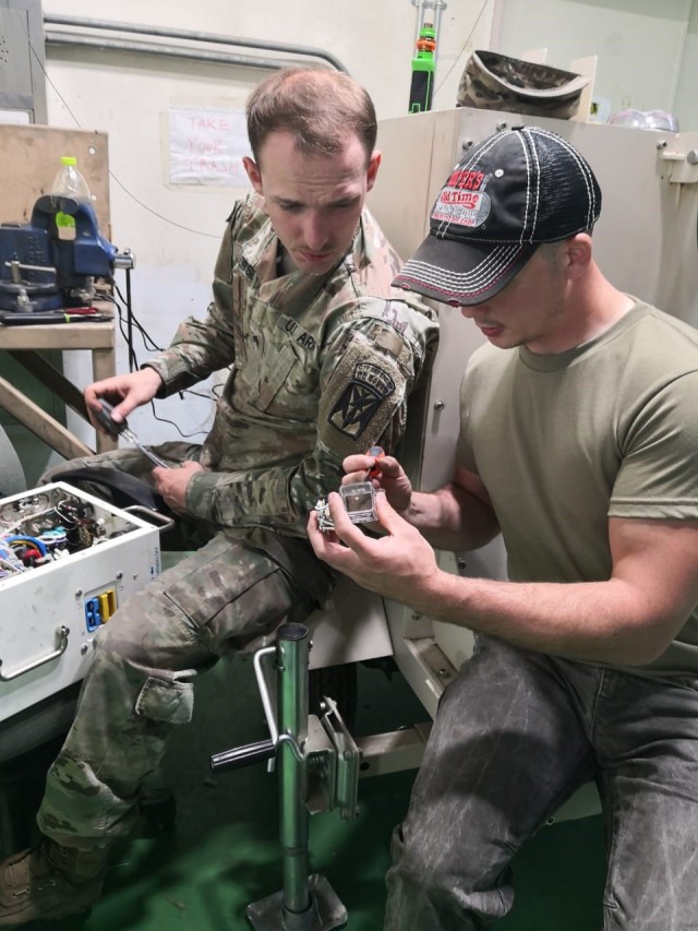 Generator Technician Johnathan Persinger, right, works with Soldiers to repair environmental control units and generators while assigned to the regional support center in Korea.  Tobyhanna Army Depot Depot Maintenance Forward employees also teach...