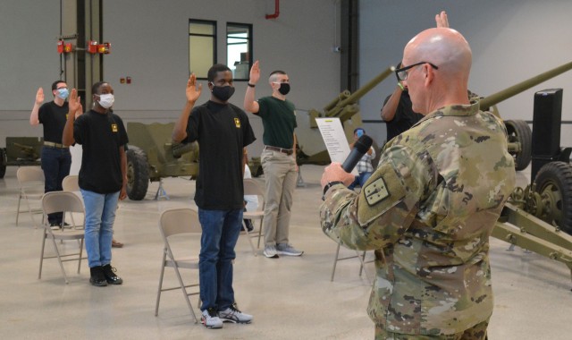 Maj. Gen. Rodney D. Fogg, Combined Arms Support Command and Fort Lee commanding general, reads the Oath of Enlistment so it can be repeated by new Army recruits during a swearing-in ceremony June 22 on the exhibit floor of the Ordnance Training Facility. Nineteen young men and women participated in the special event that was meant to raise awareness of the Virtual National Hiring Days campaign set for June 30-July 2.