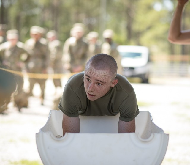 A trainee with 2nd Battalion, 60th Infantry Regiment puts his arms in an arm immersion cooling tank during training. The tanks allow Soldiers to rapidly cool by putting their forearms into a tank of ice water. (Photo by Saskia Gabriel)
