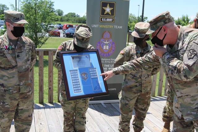 FORT GEORGE G. MEADE, Md. – Chap. (Col.) Rick Cantrell, the U.S. Army Intelligence and Security Command (INSCOM) chaplain, points to the plate signaling the 781st Military Intelligence (MI) Battalion (Cyber) Unit Ministry Team (UMT) beat out 40...