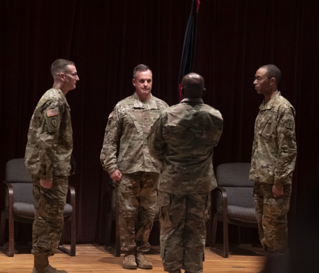 From left: Col. Michael Tigue, former Adjutant General School commandant, Col. Steven Aiton, Soldier Support Institute commander, and Col. Marcus Motley, AG school commandant prepare to pass the virtual guidon during a change of command ceremony...