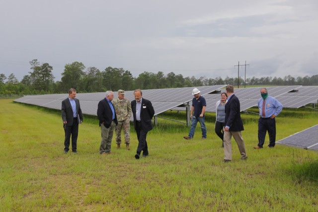 FORT BENNING, Ga. – At a 216-acre solar farm on Fort Benning June 25, Bryan M. Gossage (second from right), principal deputy assistant secretary of the Army for installations, energy and environment, and Jack Surash (fourth from left), acting deputy assistant secretary of the Army for energy and sustainability, get filled in on energy-related matters. The stop was one of several during a visit the officials made for insight into the post&#39;s efforts with renovation of Family homes and Soldier barracks, energy initiatives, and other key matters. With them are Col. Matthew Scalia (third from left), commander of U.S. Army Garrison Fort Benning, and Christopher Ferris (second from left), USAG Fort Benning&#39;s deputy to the garrison commander.

(U.S. Army photo by Markeith Horace, Maneuver Center of Excellence and Fort Benning Public Affairs)