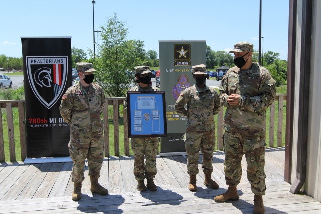 FORT GEORGE G. MEADE, Md. – Master Sgt. David Kress, the U.S. Army Intelligence and Security Command (INSCOM) religious affairs specialist, presents a plaque to (left to right) Chap. (Capt.) Michael Cerula, the 781st Military Intelligence (MI)...