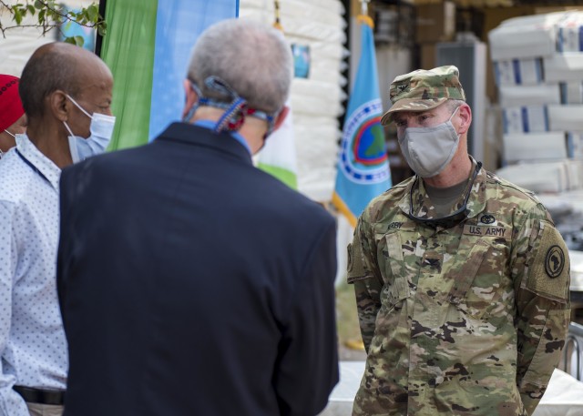 U.S. Army Col. James Kerby, deputy surgeon, Combined Joint Task Force-Horn of Africa (CJTF-HOA), speaks with Larry E. André, U.S. Ambassador to Djibouti, and Dr. Saleh Banoita Tourab, Executive Secretary of the Djiboutian Ministry of Health, prior to a ceremony at Bouffard Hospital in Djibouti City, Djibouti, June 25, 2020. CJTF-HOA donated 60 beds valued at $9,400 to the Djiboutian Ministry of Health for its efforts during the ongoing COVID-19 pandemic. (U.S. Air Force photo by Senior Airman Dylan Murakami)