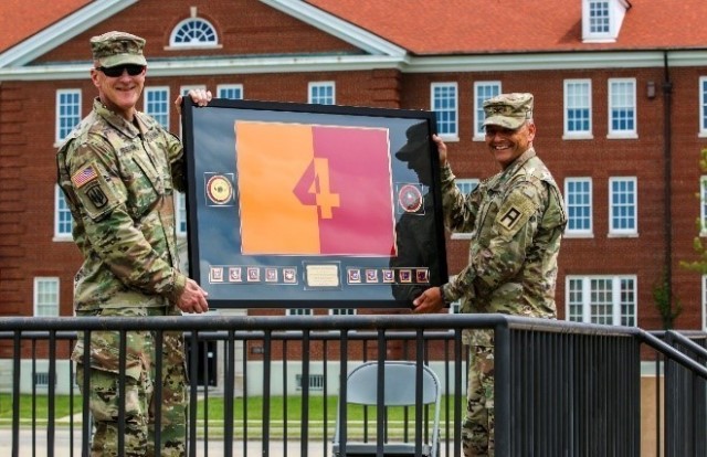Command Sgt. Maj. Donald W. Ferguson, the 4th Cavalry Multi-Functional Training Brigade’s Senior enlisted advisor, presents Col. James L. Turner, the 4th Cavalry Brigade commander, with a going away gift on behalf of 4th Cav., June 16 at Brooks...