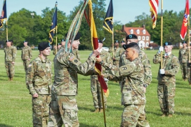 Col. James L. Turner, the outgoing commander of 4th Cavalry Multi-Functional Training Brigade commander passes the colors to Maj. Gen Terrence J. McKenrick, First Army Division East commander symbolizing his relinquishment of command during the 4th Cav. Change of Command held June 17 at Brooks Field at Fort Knox, Ky. Col. Turner relinquishes command after 2 year at 4th Cavalry Brigade and will be heading to Florida to work at CENTCOM Headquarters. (US Army Photo by Mark Webber)