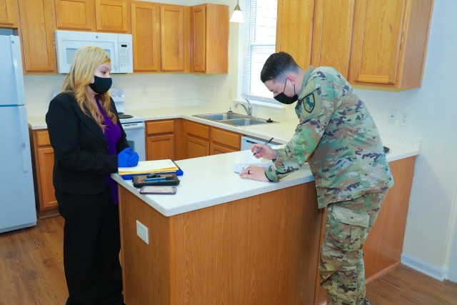 FORT BENNING, Ga. – A drill sergeant newly assigned to Fort Benning's 199th Infantry Brigade signs a move-in inspection form June 25 at the home he will move into on Fort Benning. Because of the COVID-19 pandemic, housing officials here have...