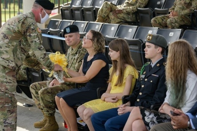 Mrs. Brigette Gallagher, wife of the incoming commander Col. Timothy Gallagher is presented a bouquet of yellow roses, welcoming her and her family to the unit during the 4th Cavalry Multi-Functional Training Brigade Change of Command Ceremony...