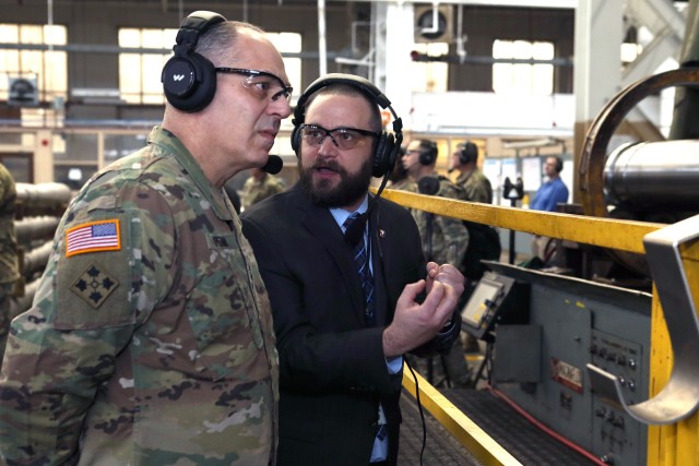 The commander of the Army Materiel Command, Gen. Gus Perna, being briefed by Machinist Supervisor Terry Van Vranken during the Secretary of the Army's tour.
