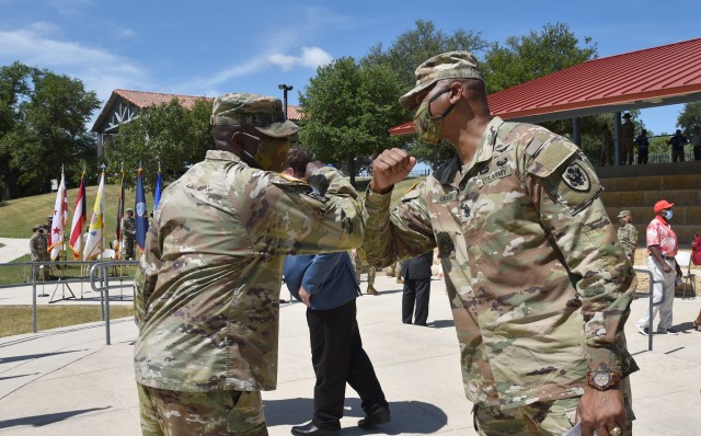 The U.S. Army Surgeon General and Commanding General, U.S. Army Medical Command, Lt. Gen. R. Scott Dingle, bumps elbows observing social distancing approved greetings with former U.S. Army Medical Command, Command Sgt. Maj. Michael L. Gragg, on Fort Sam Houston, Texas, on June 24, 2020. (U.S. Army Photo by Rebecca Westfall, MEDCOM/OTSG)