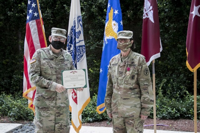Brig. Gen. George “Ned” Appenzeller, Regional Health Command-Central Commanding General, presents outgoing Brooke Army Medical Center Commanding General, Brig. Gen. Wendy L. Harter the Legion of Merit prior to her change of command ceremony,...