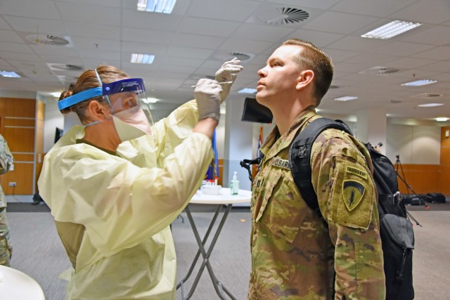 WIESBADEN, Germany - A medical professional from the Wiesbaden Army Health Clinic administers a COVID-19 test to a Soldier June 30 at the Mission Command Center at U.S. Army Garrison Wiesbaden. The tests were given to a sample population of about 50 people with no coronavirus symptoms that day as part of a surveillance testing program to ensure a safe work environment and promote readiness.