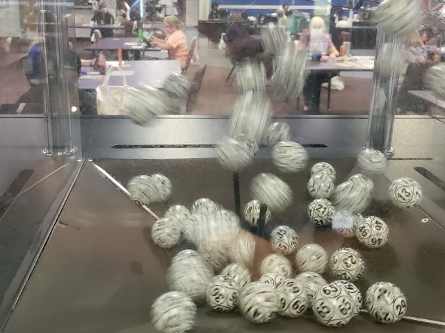 Bingo balls bounce around inside a hopper while bingo players scan their game cards as numbers are called out during bingo night June 25, 2020, at Hunter Army Airfield, Savannah, Ga. Organizers at the bingo facility have worked to improve the area...