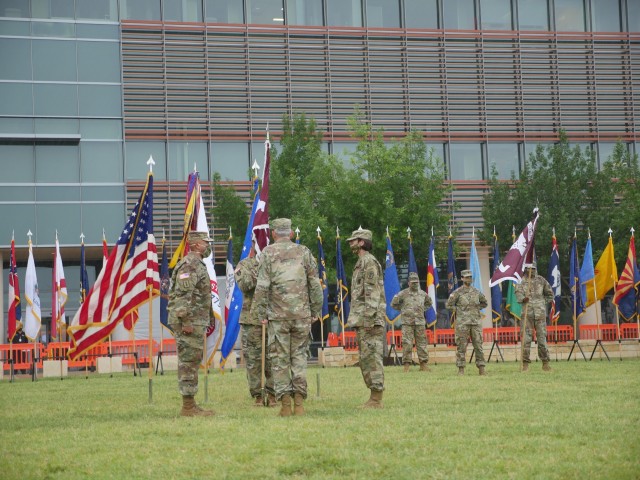 Brig. Gen. George “Ned” Appenzeller, Regional Health Command-Central Commanding General, center, prepares to pass the Brooke Army Medical Center colors to outgoing BAMC Commanding General, Brig. Gen. Wendy L. Harter, right, to incoming...