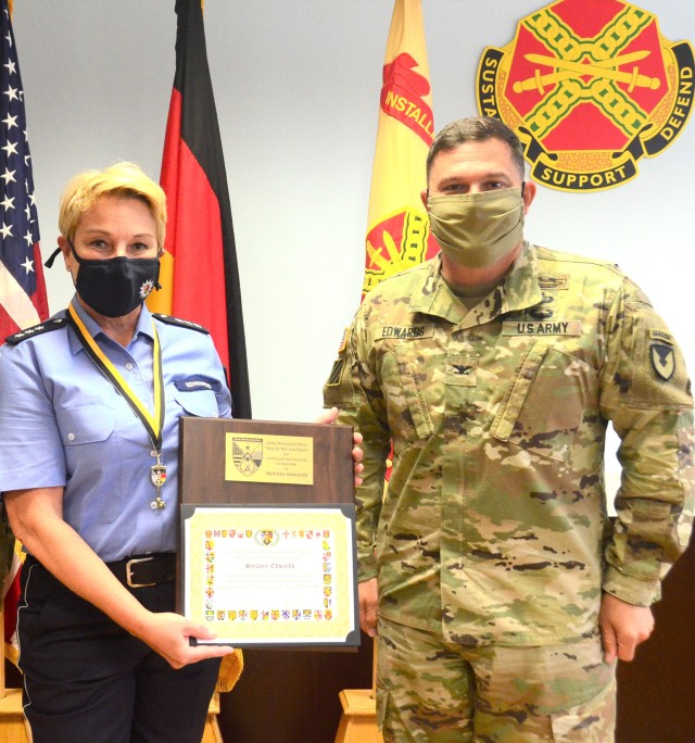 Stefanie Edwards, Landstuhl Police Liaison Officer, poses with Col. Jason Edwards, U.S. Army Garrison Rheinland-Pfalz commander, after Edwards presented her with a Key to the Garrison in a small ceremony in late June.
