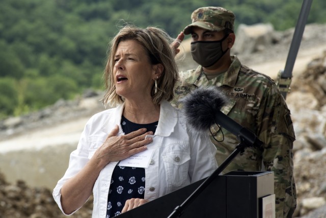 Tennessee District 40 Rep. Terri Lynn Weaver sings the National Anthem at the Center Hill Lake Auxiliary Dam July 1, 2020 during a ceremony celebrating the completion of the last phase of repairs for the $353 million Center Hill Dam Safety Rehabilitation Project. The U.S. Army Corps of Engineers Nashville District recently finished constructing a roller compacted concrete berm to reinforce the auxiliary dam at Center Hill Lake, a secondary earthen embankment that fills a low area in the landscape just east of the main dam. (USACE Photo by Leon Roberts)