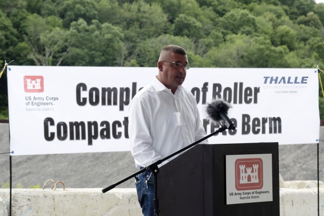 Steve Kohler, president and chief executive officer of Thalle Construction Corporation, speaks about the technical processes of constructing a roller compacted concrete berm and challenges the contractor faced and overcame during a ceremony July...