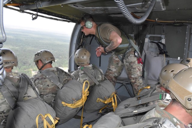 A jumpmaster gives instructions to 1st Battalion (Airborne), 509th Infantry Regiment paratroops before they exit a UH-60 Black Hawk helicopter July 1 at the JRTC and Fort Polk Geronimo Drop Zone.
