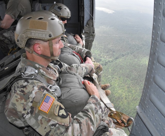 1st Bn (Abn), 509th Inf Reg Paratroopers prepare to leap from a UH-60 Black Hawk helicopter over the JRTC and Fort Polk Geronimo DZ on July 1.