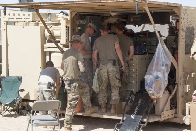 Mechanics from the B Company 145th Brigade Support Battalion reorganize the tools in their M7 Forward Repair System after completing a job at the National Training Center (NTC) in Fort Irwin, Calif., June 10, 2019. (National Guard photo by Capt....