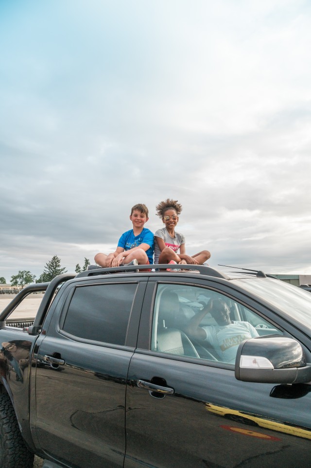 WIESBADEN, Germany - While dad sits in the driver's seat of his parked pickup truck, the children wait on the top of the cab for the fireworks to begin at Wiesbaden Army Airfield July 4, 2020.
